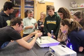 VIMS grad student Bruce Pfirrman shows a blue crab to Blue Crab Bowl participants in a pre-tournament tour of VIMS' research laboratories. ©C. Katella/VIMS.