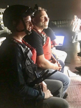 Emily Hein wears a helmet-mounted camera to stream live video back to shore as part of Verizon’s test of night-vision capabilities and other response tools. Also pictured is Brian Province of Maersk. © Aaron Allen, Maersk Line, Ltd.