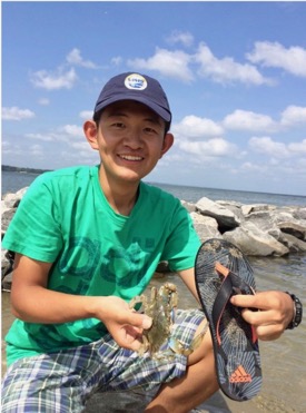 Fei Da enjoys a moment of levity on a Chesapeake Bay beach.